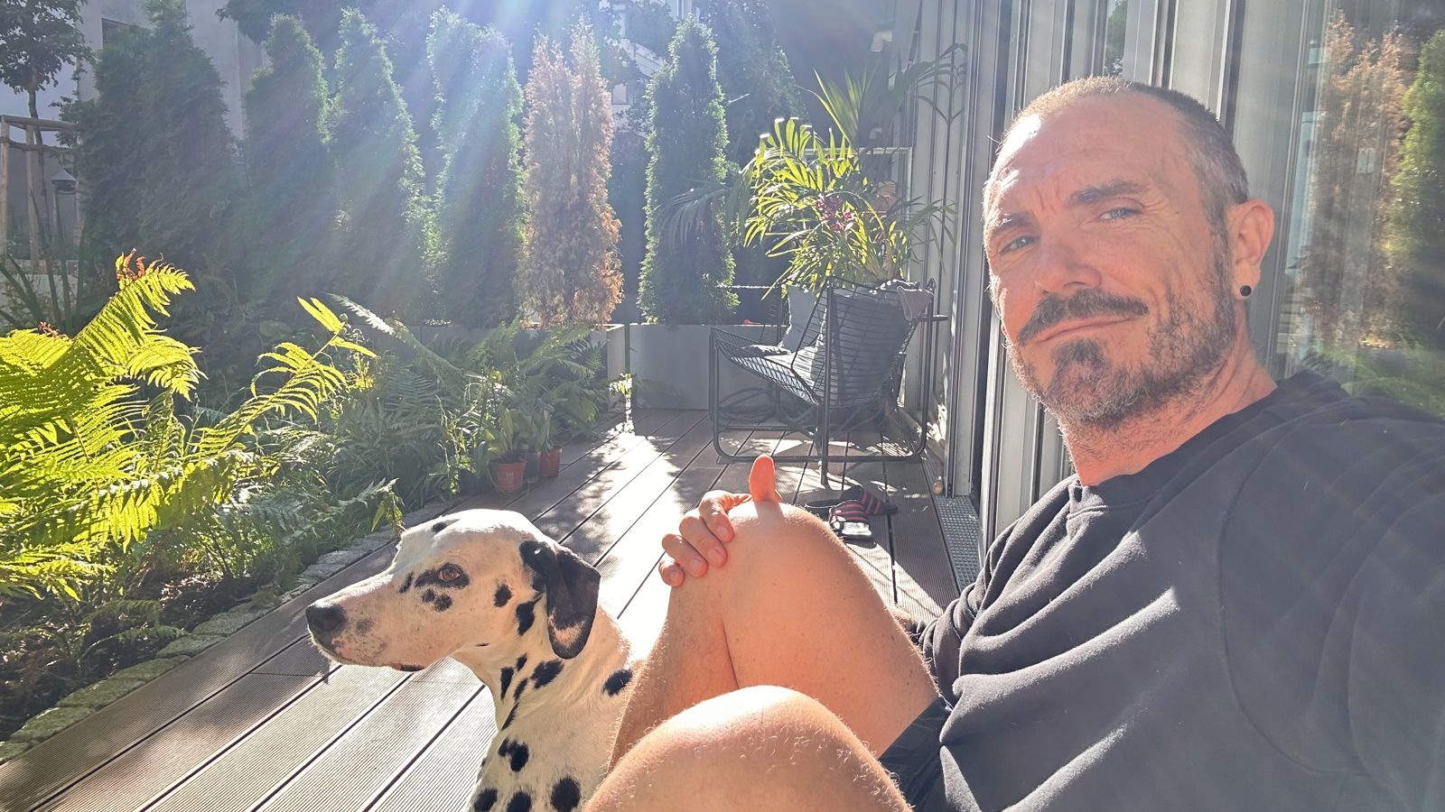 Alek Martin with his Dalmatian Loki on his terrace in Berlin